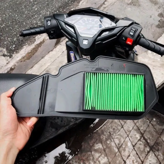 Hình ảnh kỹ thuật viên đang vệ sinh hoặc thay thế lọc gió xe máy